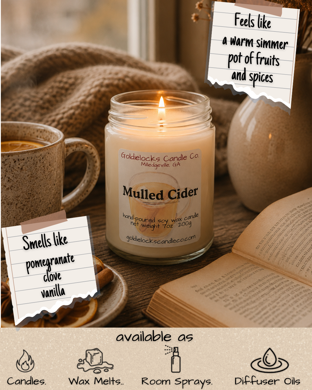 A cozy scene featuring a lit candle labeled 'Mulled Cider,' a mug of hot drink, an open book, and notes indicating the candle smells like pomegranate, clove, and vanilla, and feels like a warm simmer pot of fruits and spices. The candle is from Goldielocks Candle Co., and the scene suggests the candle is available as candles, wax melts, room sprays, or diffuser oils.