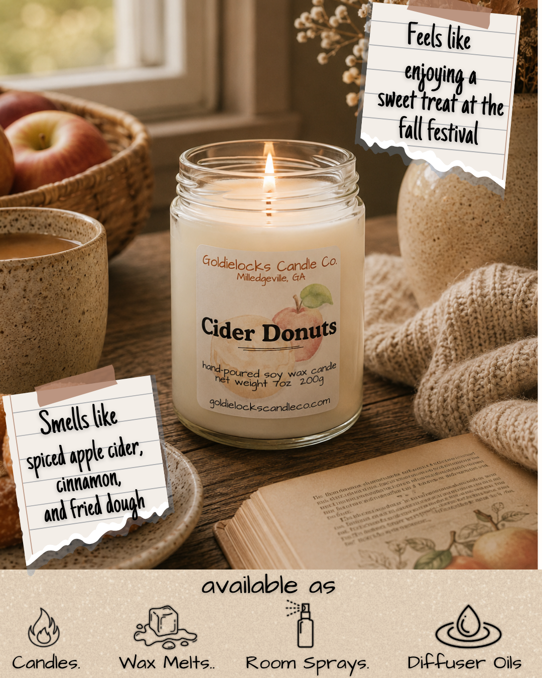 A lit candle labeled 'Cider Donuts' on a wooden table alongside a cup of coffee, a basket of apples, a folded knitted blanket, and an open book. Two notes with handwritten text read: 'Feels like enjoying a sweet treat at the fall festival' and 'Smells like spiced apple cider, cinnamon, and fried dough.'