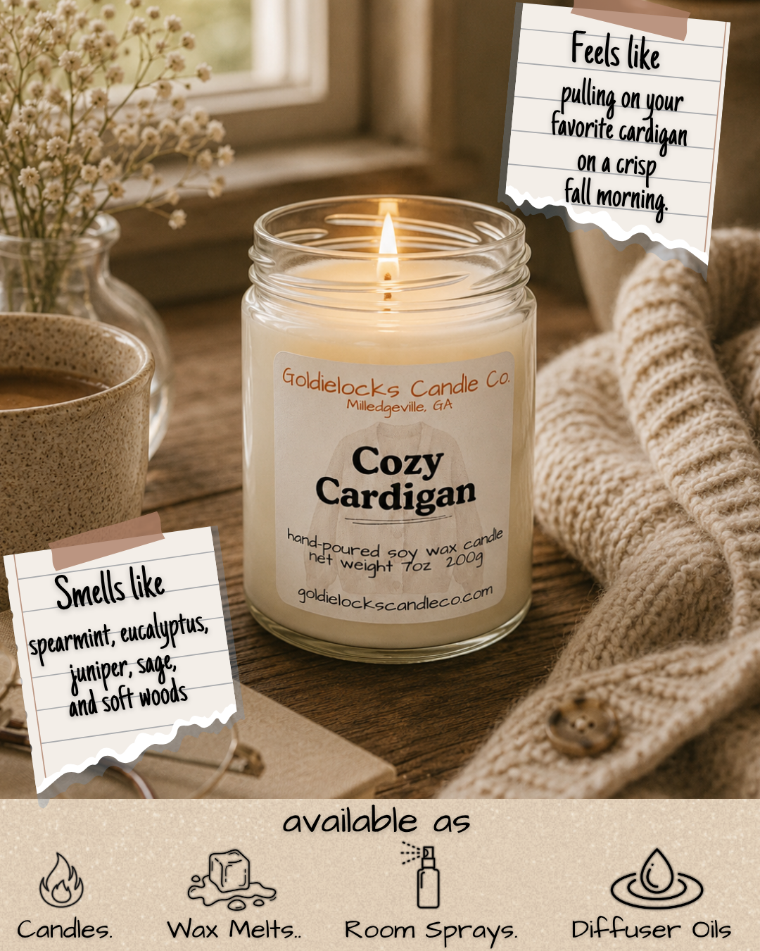 A cozy scene featuring a lit candle in a jar labeled "Cozy Cardigan" from Goldielocks Candle Co., a cup of coffee, a bunch of white flowers, a knitted blanket, and two notes with descriptions, including one noting the candle smells like spearmint, eucalyptus, juniper, sage, and soft woods, and the other saying pulling on a cardigan on a crisp fall morning. The image also highlights products like candles, wax melts, room sprays, and diffuser oils.