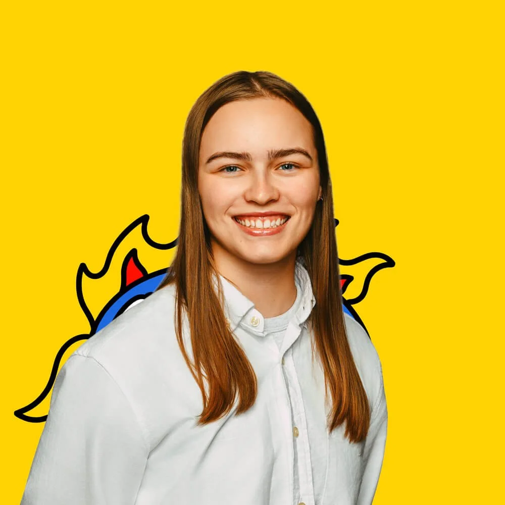 A young woman with long brown hair, smiling, wearing a white shirt, standing in front of a yellow background with a colorful cartoon dragon illustration.
