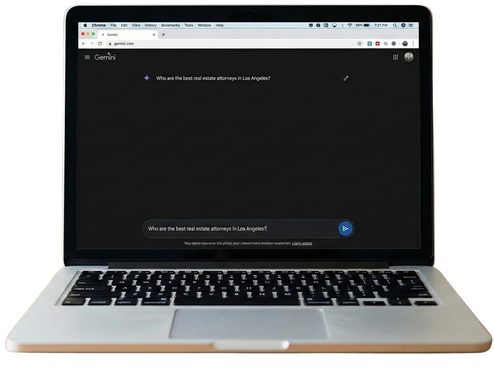A silver laptop with black keyboard displaying the Gemini website on a dark background.