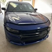 Front view of a dark blue sports cars in a showroom.