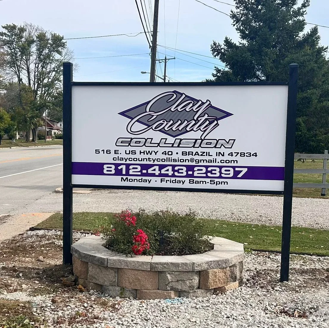 Sign for Clay County Collision with contact info and business hours, located at 516 E. US HWY 40 in Brazil, Indiana.