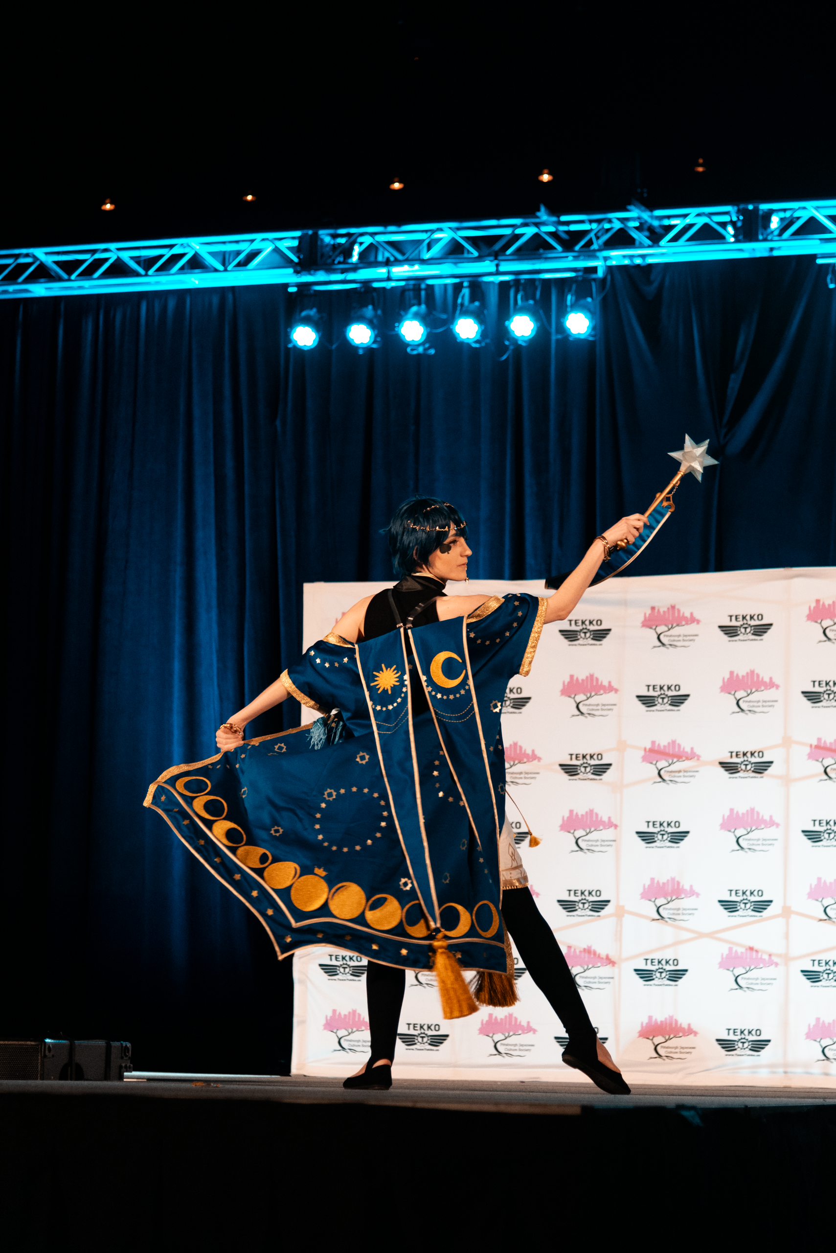 A craftsmanship winner displays the back of their elaborately patterned cape.