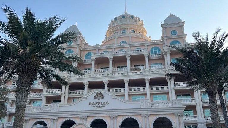 Raffles The Palm front view looking up during the early morning first light.