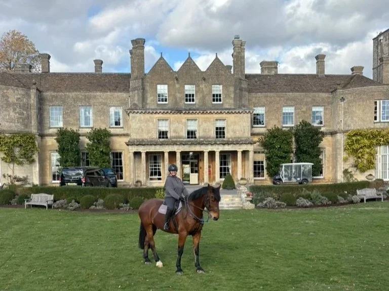 Lucknam Park house in the background with Pippa in the forefront on a brown horse Carlos.