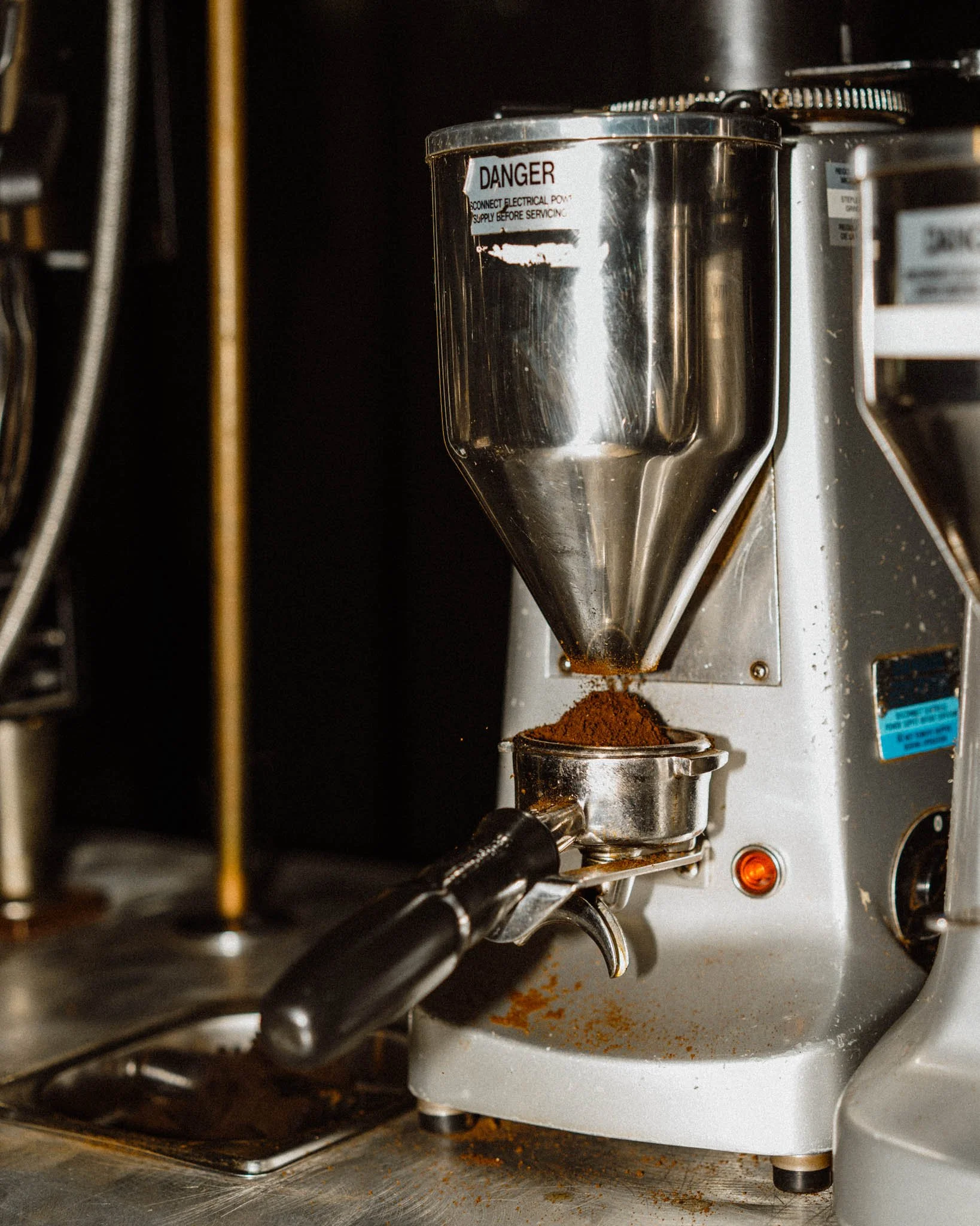 A coffee grinder with a hopper filled with ground coffee.