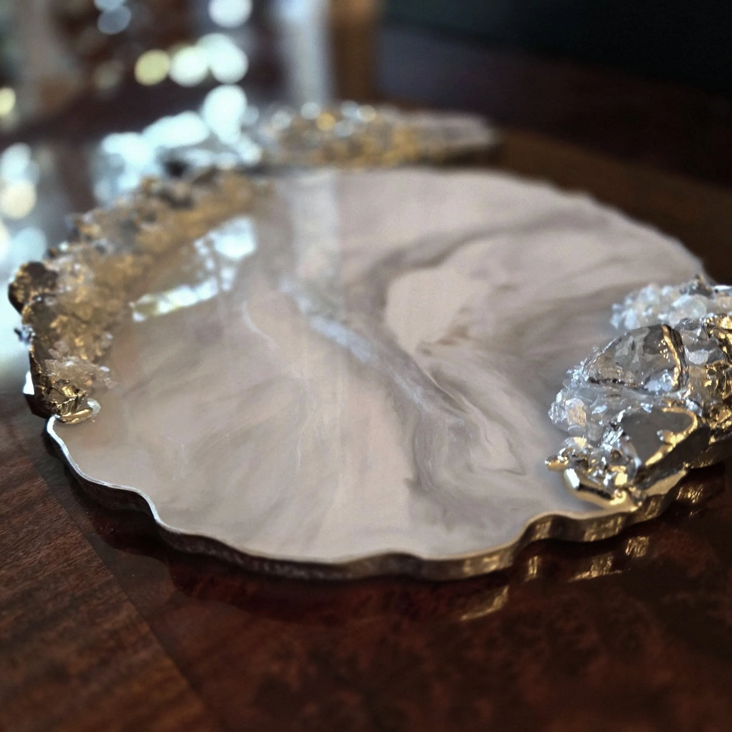 Close-up of crumpled aluminum foil on a wooden surface.