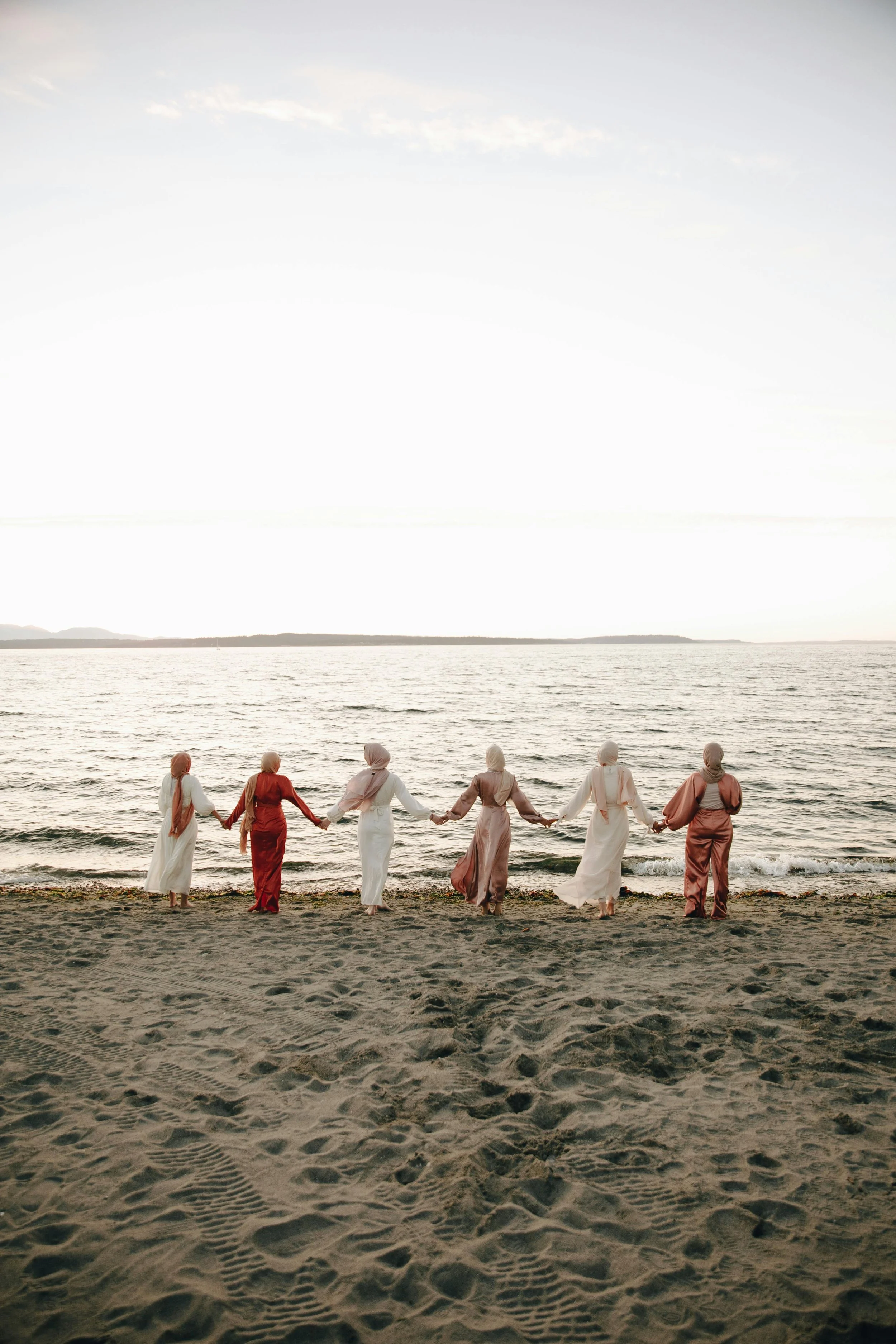 Group of people on beach representing generational trauma healing and family therapy at Intentional Therapy