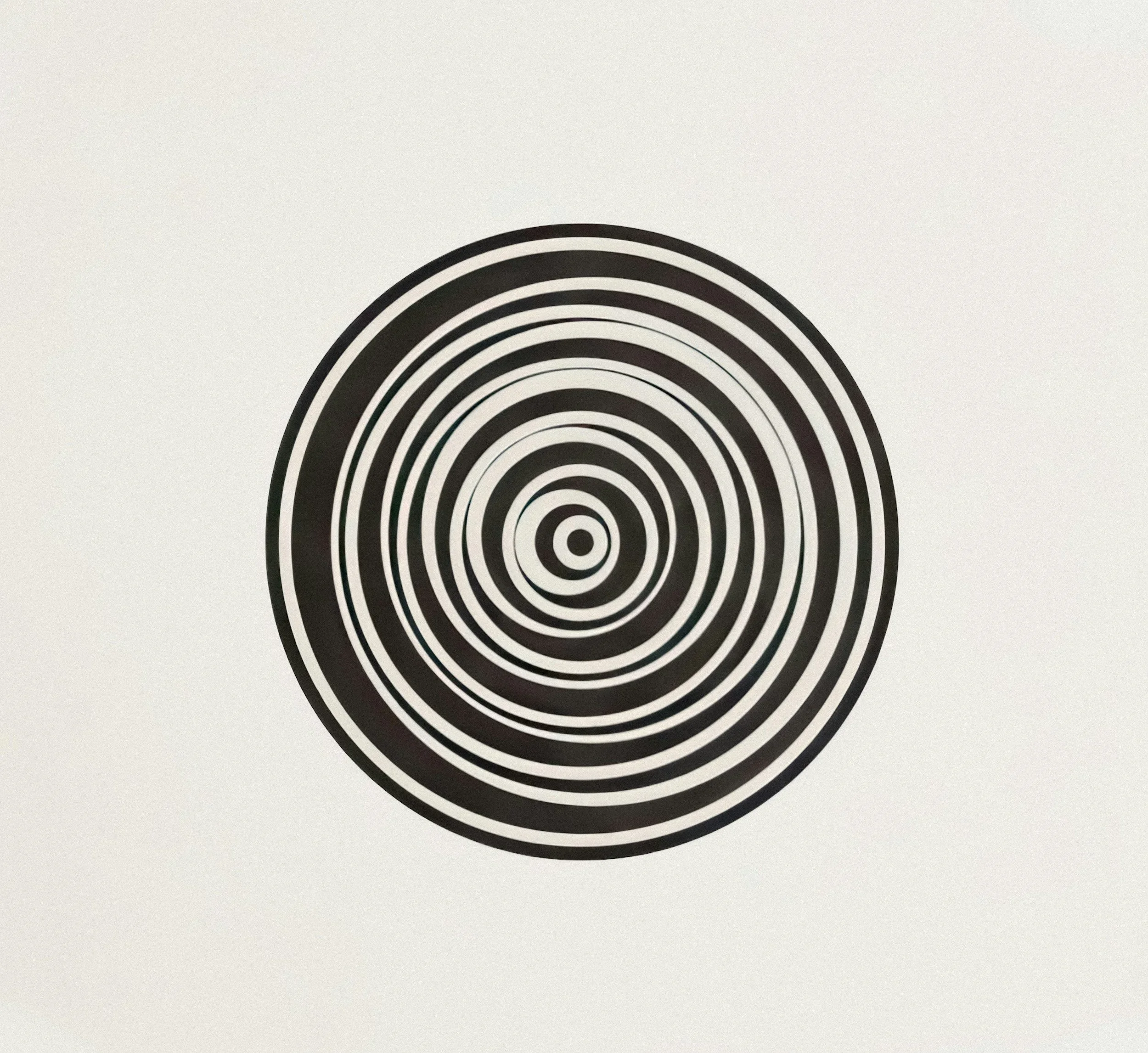 Close-up of a black and white concentric circle spiral pattern on a white background.