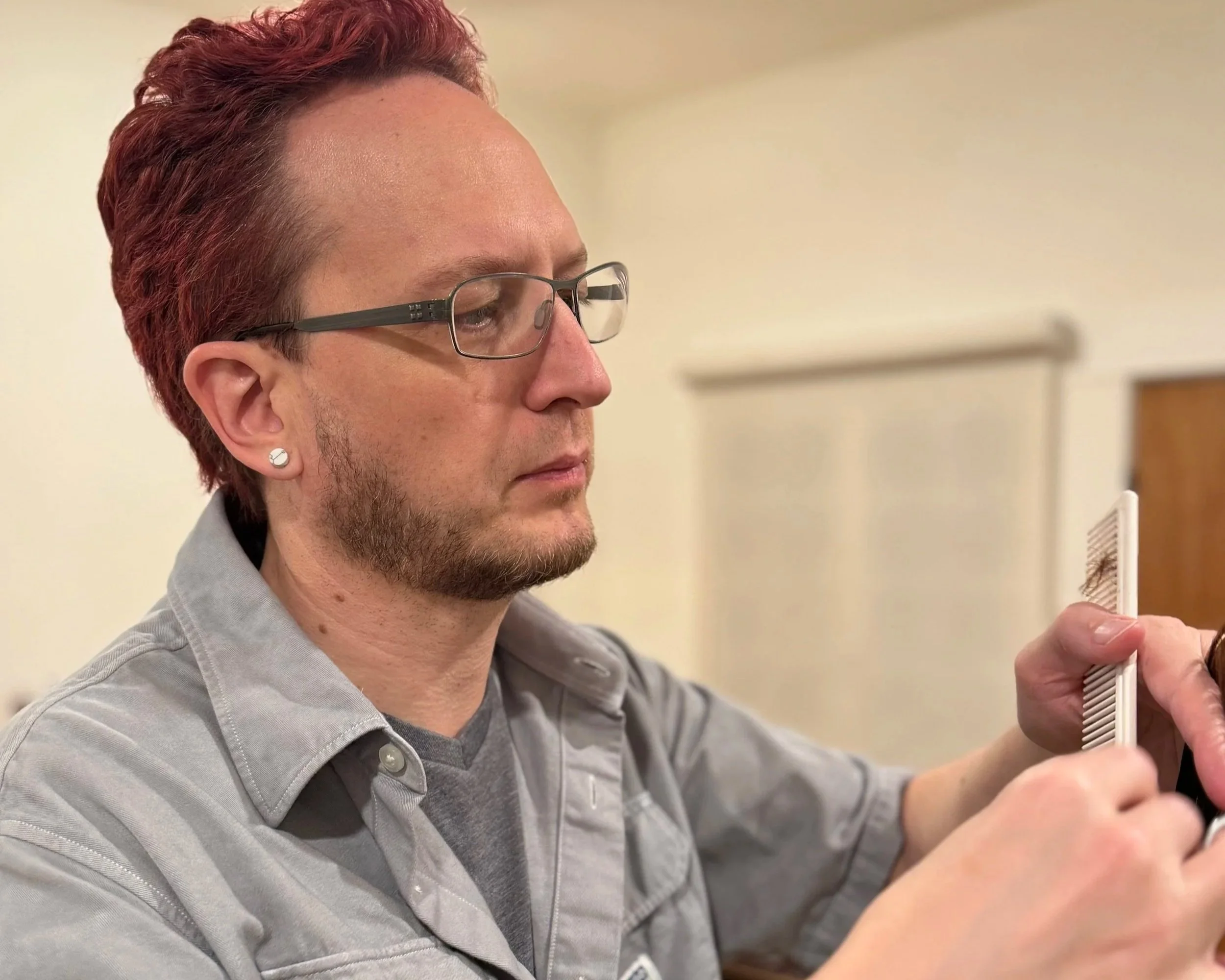 gregory b using scissors and comb on a client's medium-length hair
