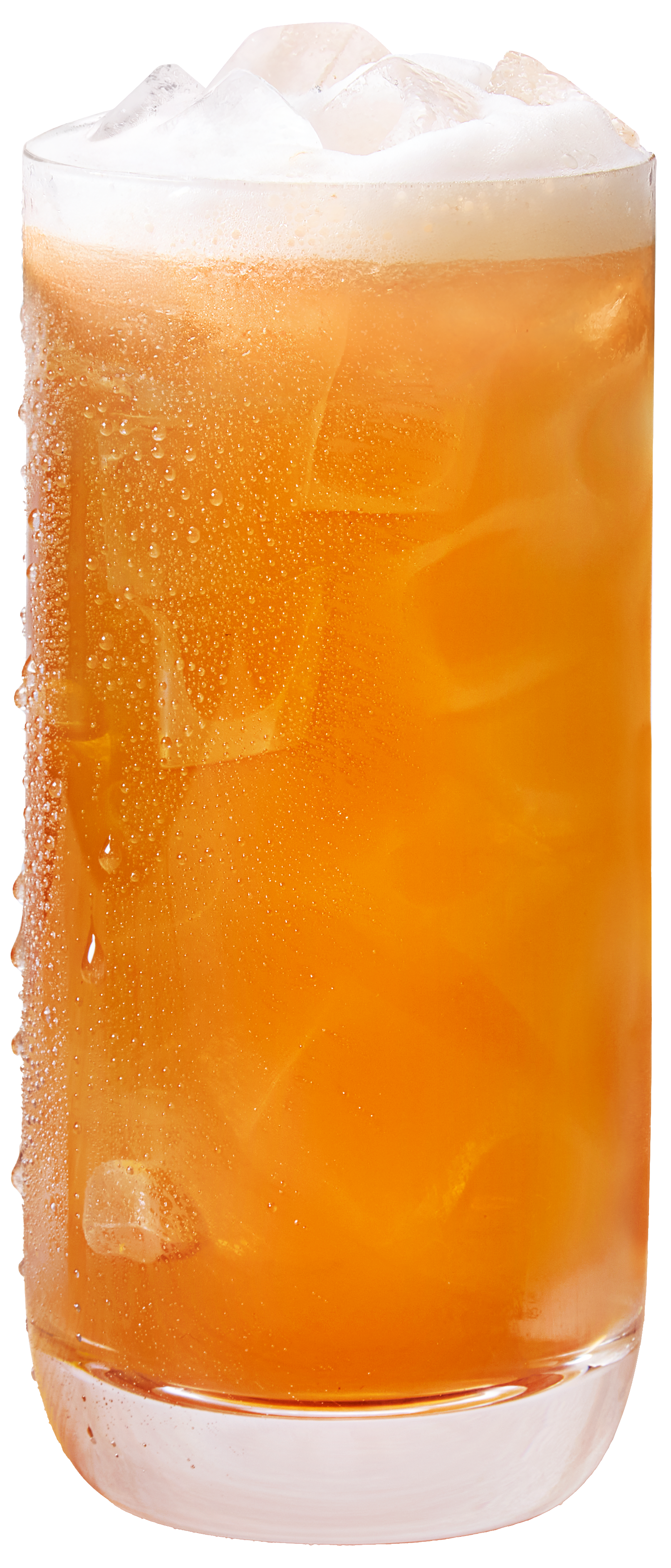 A glass of orange-colored soda with ice cubes and condensation on the outside of the glass.