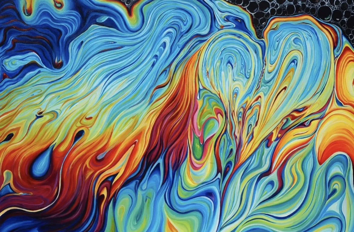 Abstract swirling paint with vibrant blues, reds, yellows, and blacks creating a fluid, dynamic pattern.