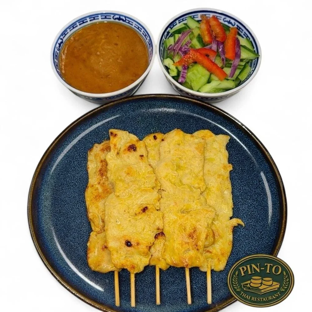 Thai-style grilled chicken skewers served with dipping sauce, a small vegetable salad, and a side of peanut sauce from Pin-To Thai Restaurant.