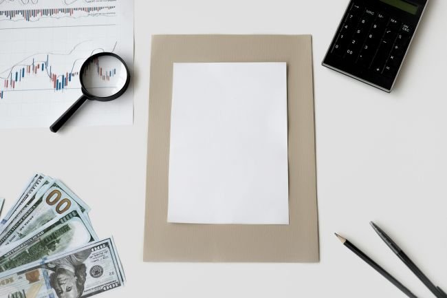 Desktop view showing paper, pens, cash, depicting what is a 401k