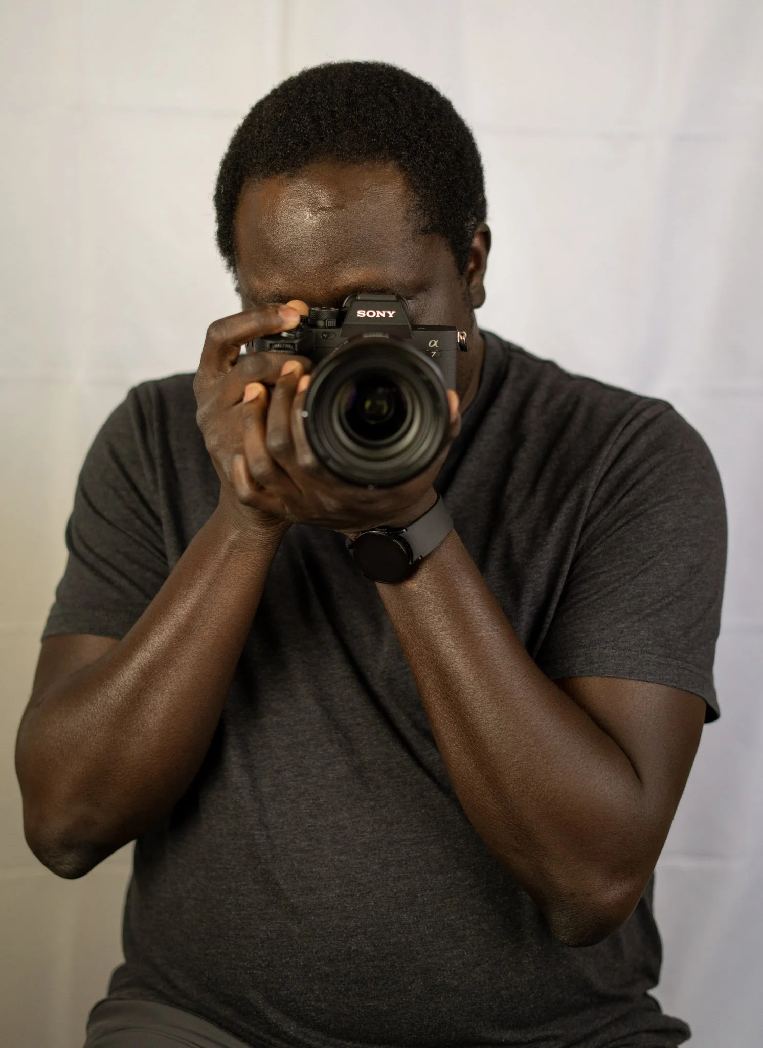 An image of a portrait and commercial photographer holding a Sony camera