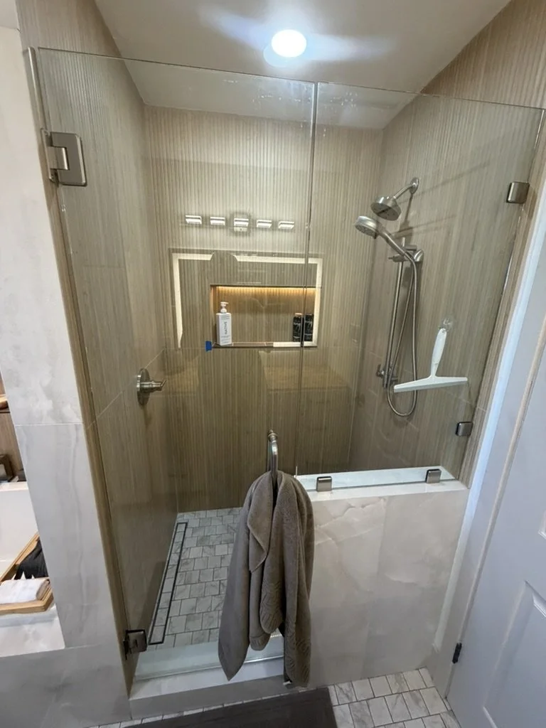 Added a custom designed walk-in shower with light custom niche
