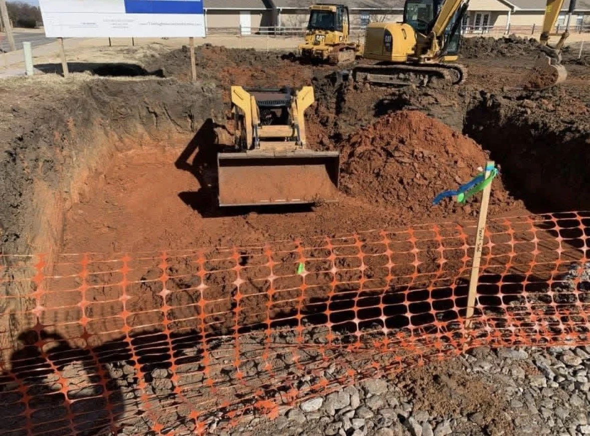 Skid Steer working on retention pond in Oklahoma City