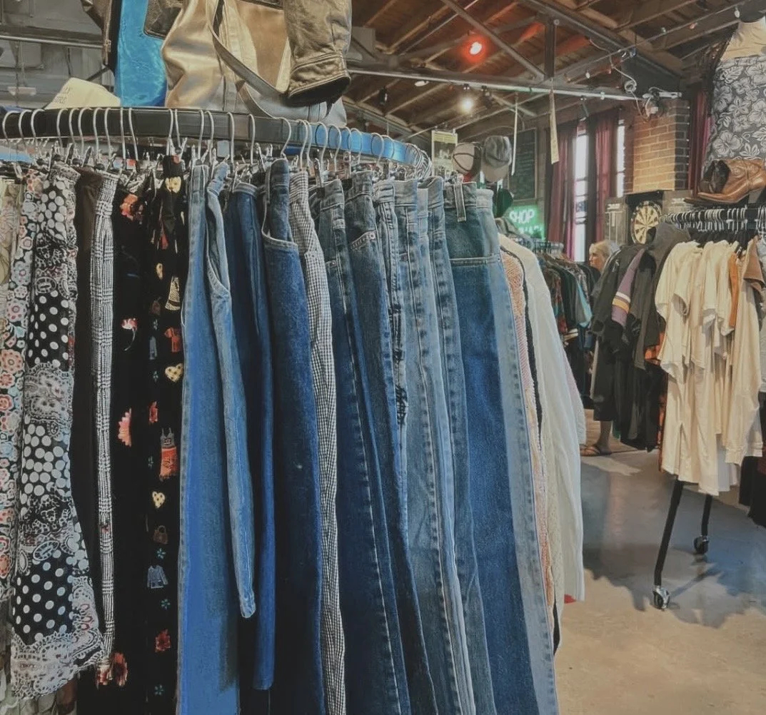 Circular clothing rack filled with second hand jeans.
