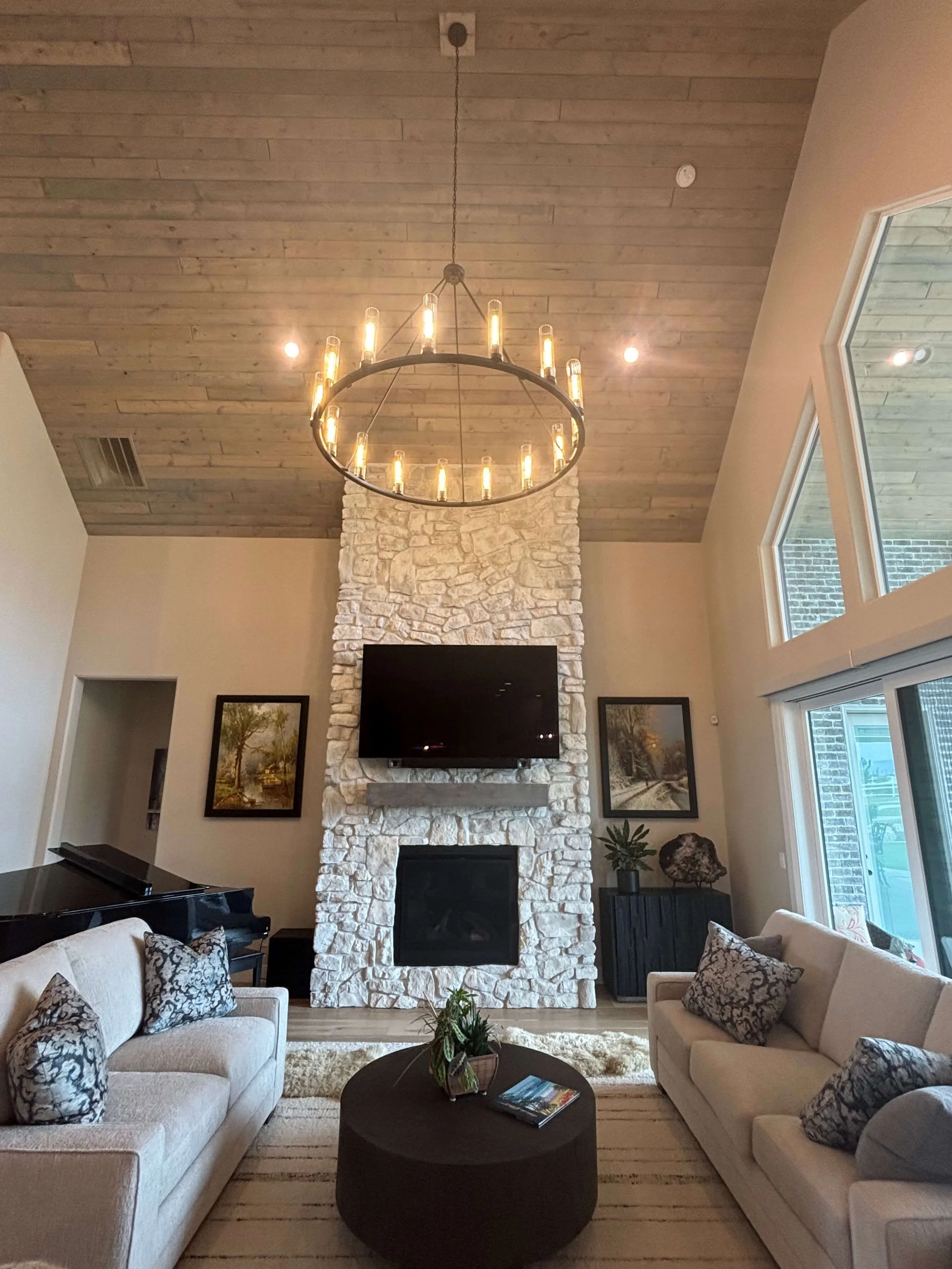 Motorized TV mount installed for TV above fireplace mantle