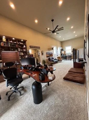 RV garage converted to home office, theater, and bar. For electric core upgrades, lighting and audio, automated shades, custom, cabinetry, insulation, heating and cooling,