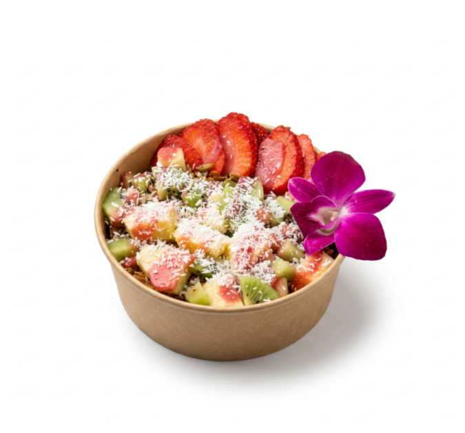 Bowl of sliced bananas, strawberries, kiwi, and coconut flakes.
