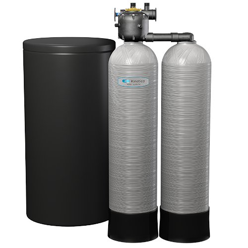 A water treatment system with a black tank and two large cylindrical resin tanks labeled 'Kinetico' connected by pipes.