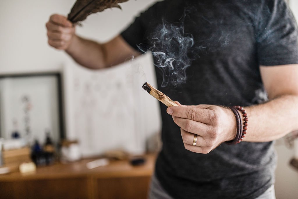 Hands holding a smoking bundle during a rites of passage ceremony in Portland Oregon