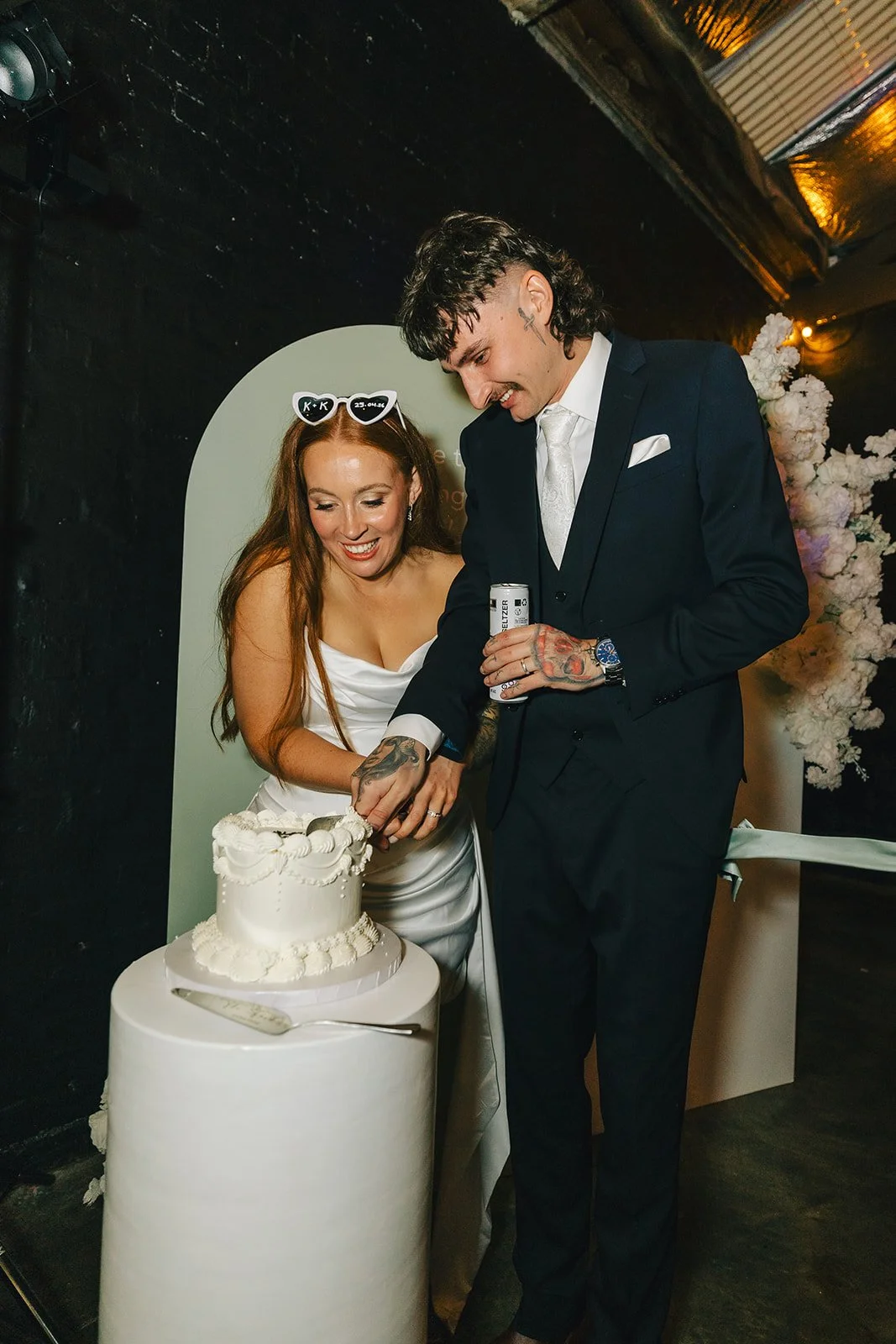 Bride and groom cutting their cake at a Warehouse 16 wedding