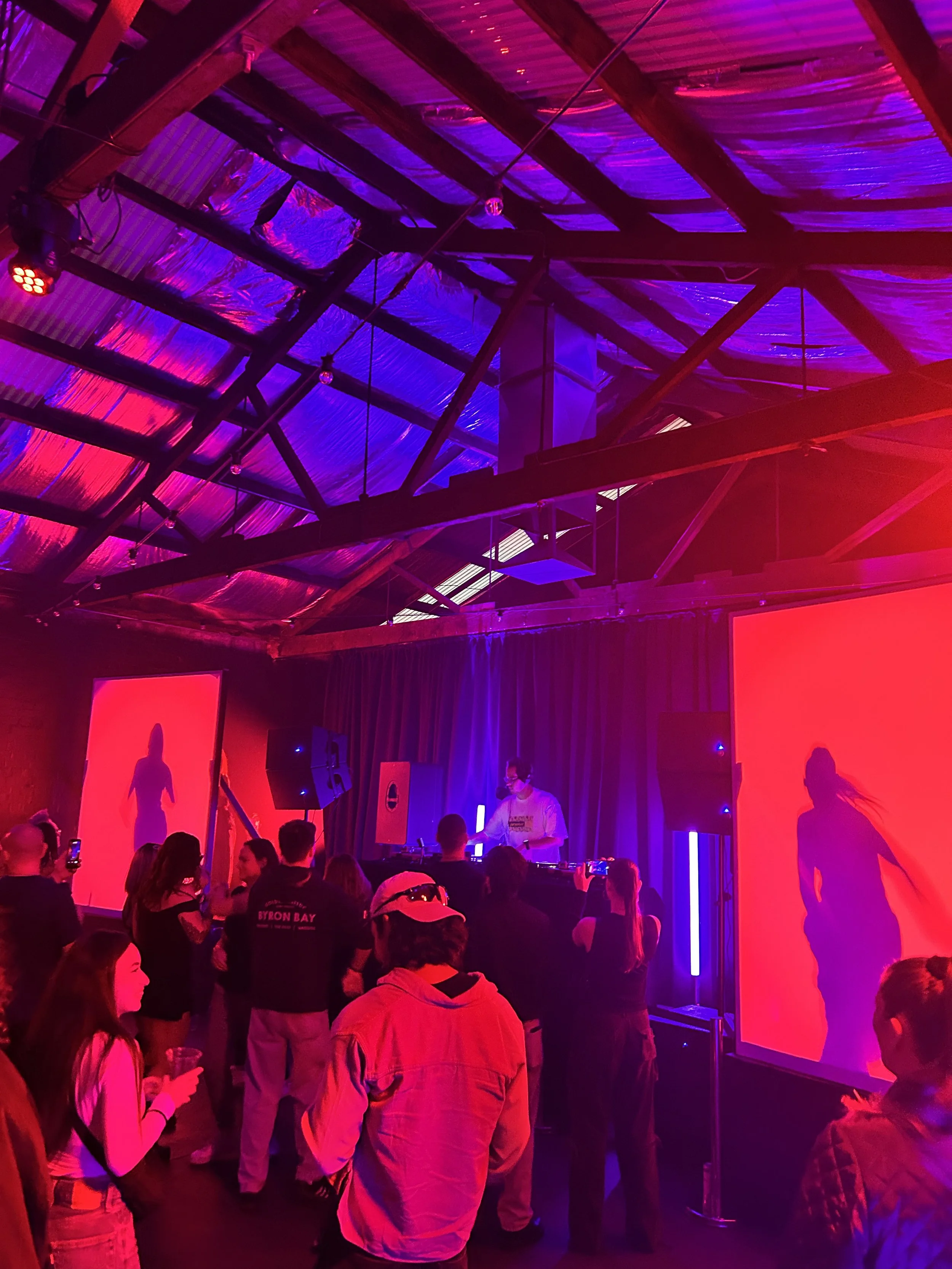 Crowd at a gig under red and purple stage lights at Warehouse 16