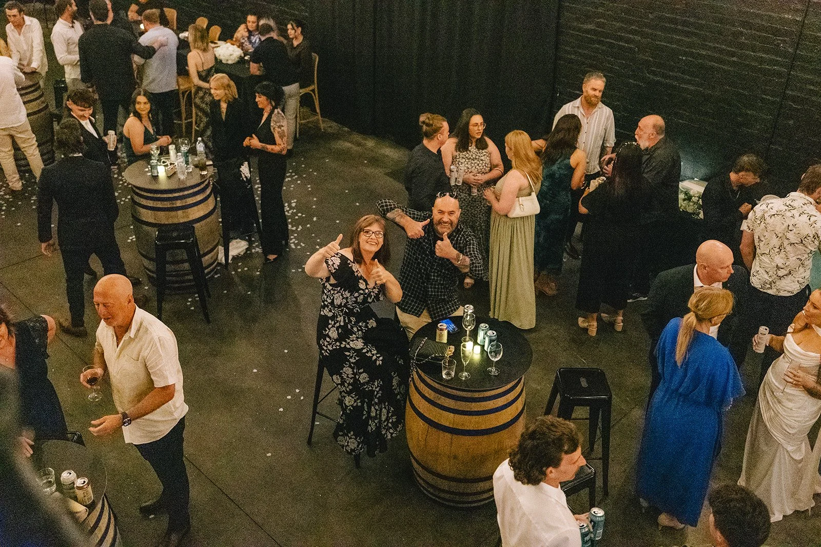Cocktail-style wedding reception with barrel tables at Warehouse 16