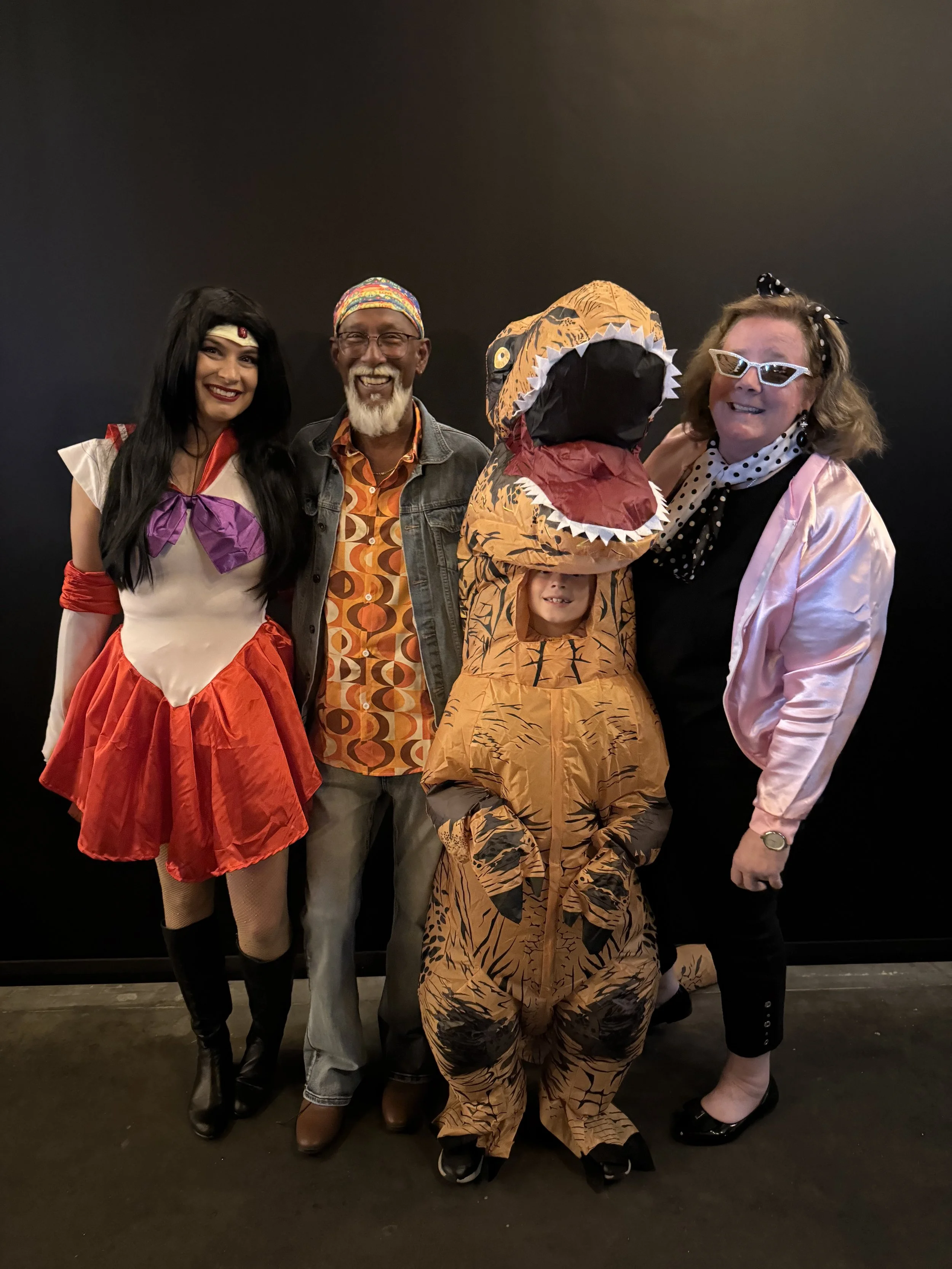 Guests in fancy dress, including a dinosaur costume, at a party at Warehouse 16