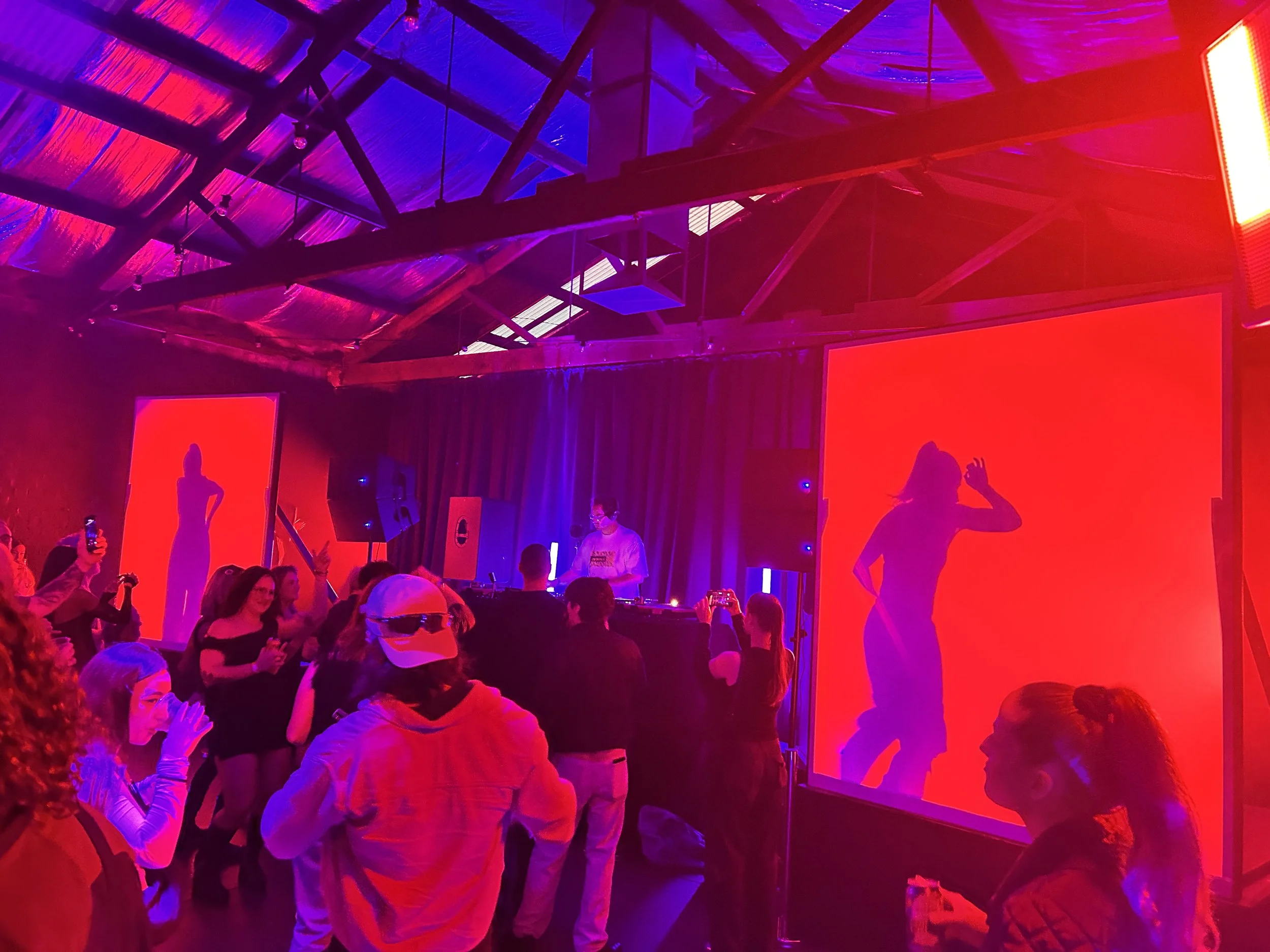 Crowd at a live music night under red and purple lights at Warehouse 16