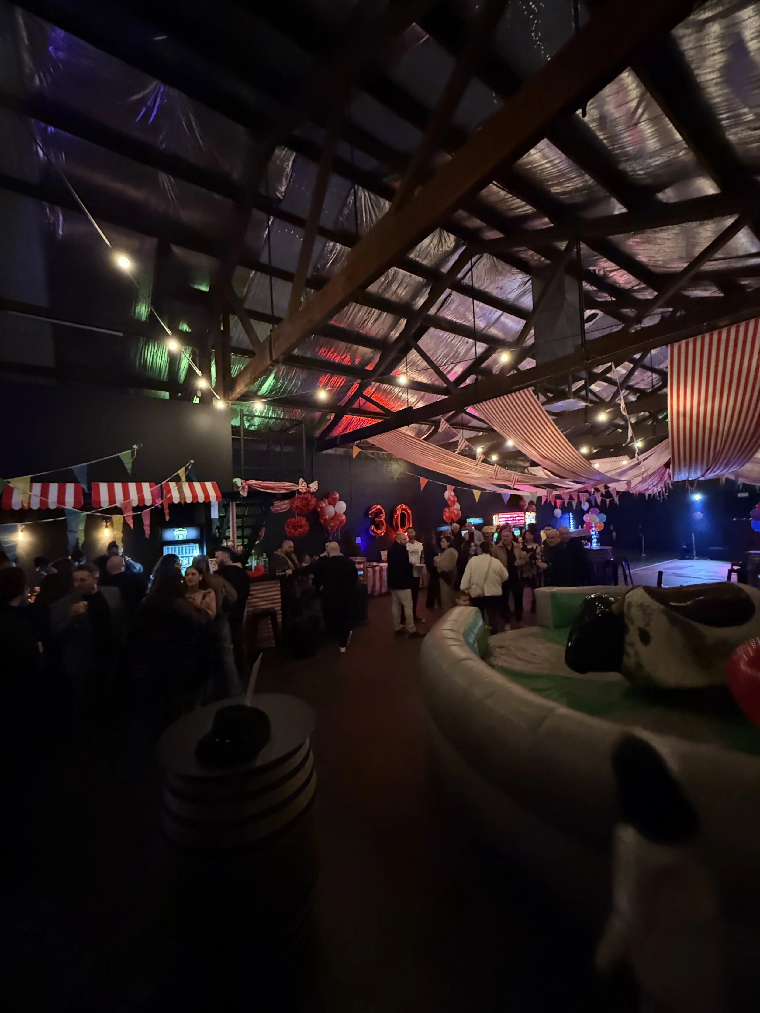 Circus-themed birthday party under festoon lights at Warehouse 16, Adelaide CBD