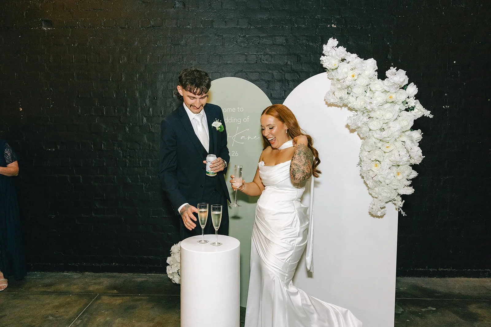 Bride and groom with drinks at their Warehouse 16 wedding reception