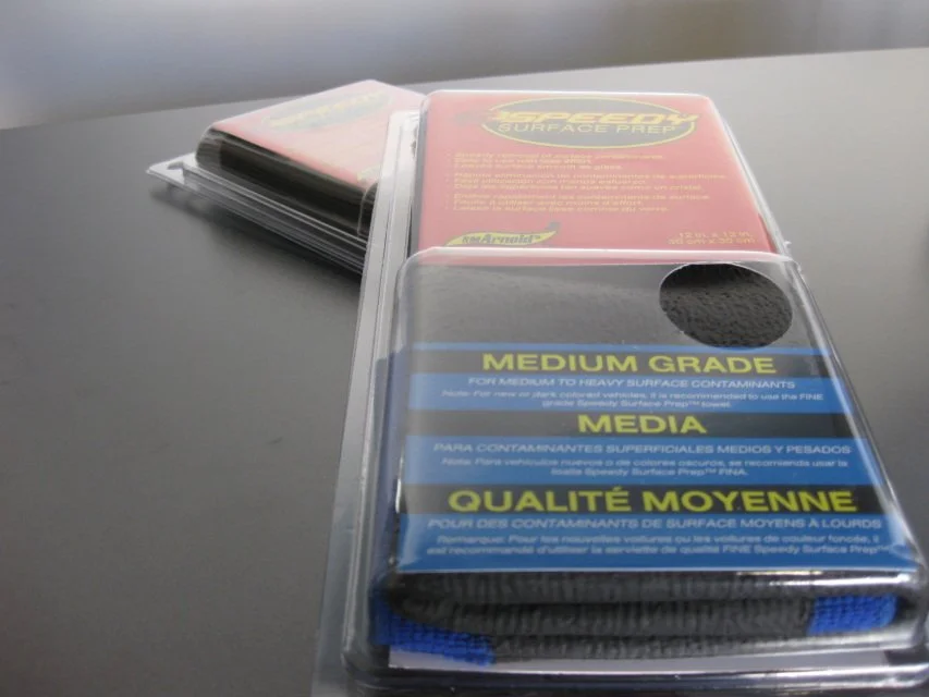 Container with labels for car paint contaminants, medium grade, suitable for moderate to heavy surface contaminants, includes a black sponge applicator.