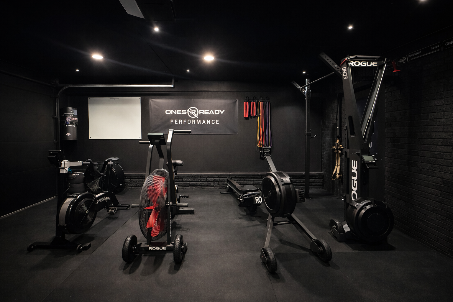 Access to a full line-up of machines including Rogue Echo Ski, Echo Rower, Echo Bike, and Concept2 Bike Erg. Bands for mobility and accessory work. 100 and 75 pound sand bags and an industrial floor fan are also available.