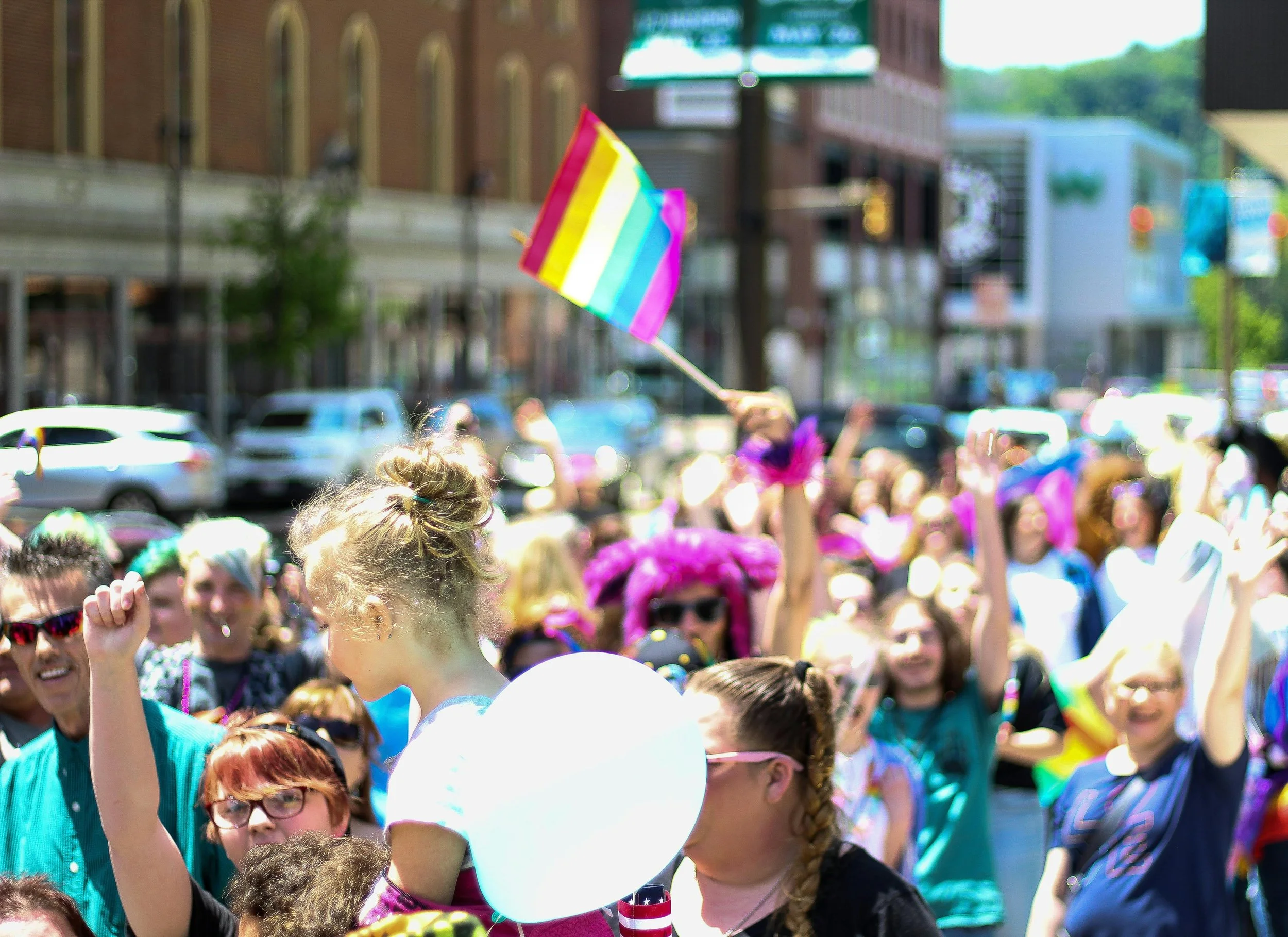 Pride Parade on busy city street.