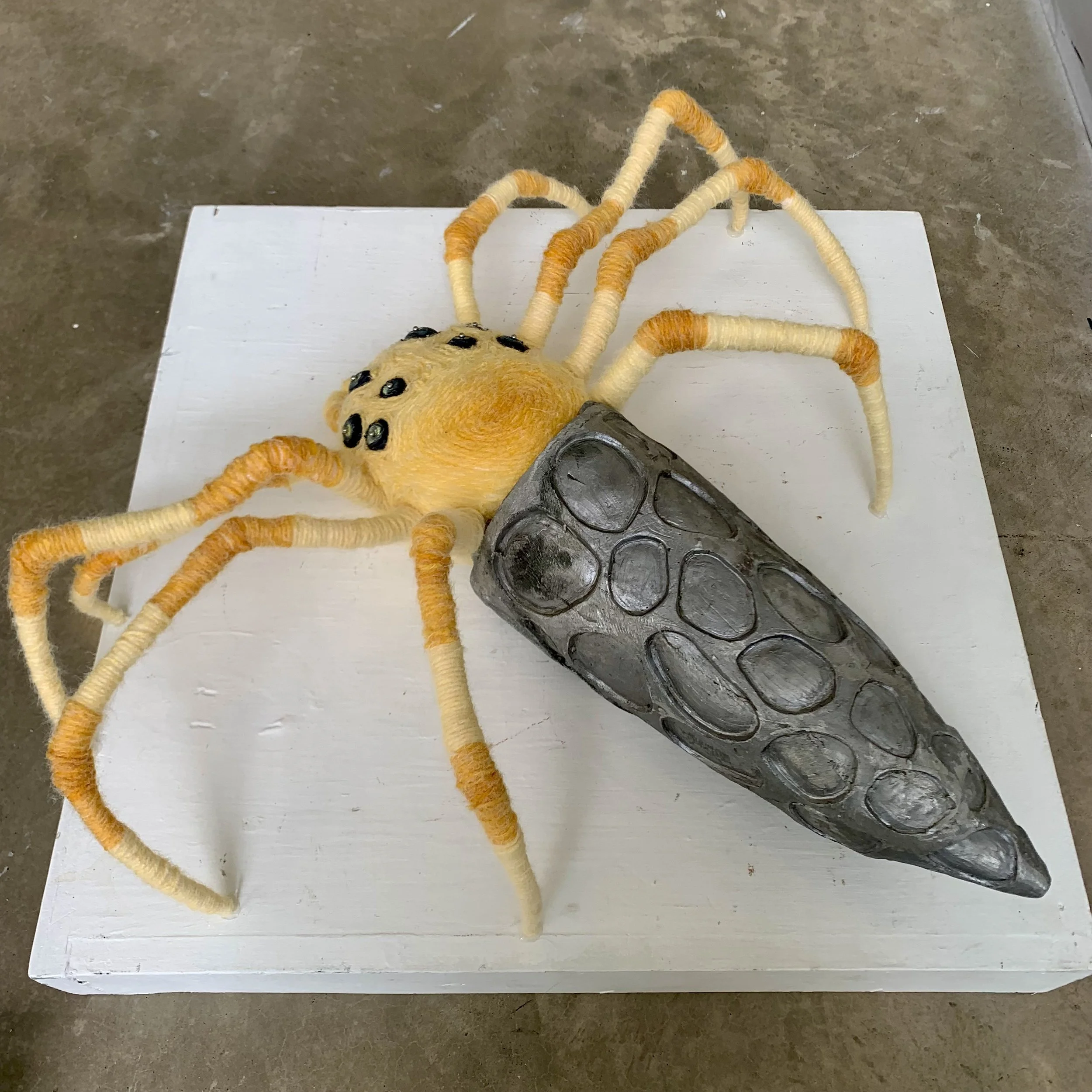 Mirror Spider, 2023. Lost wax aluminum, yarn, styrofoam, beads, pins, sand