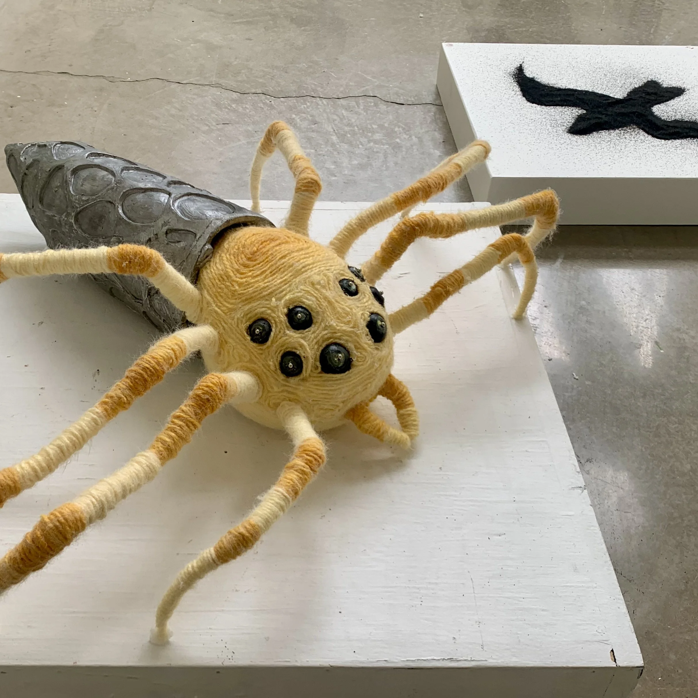 Mirror Spider, 2023. Lost wax aluminum, yarn, styrofoam, beads, pins, sand