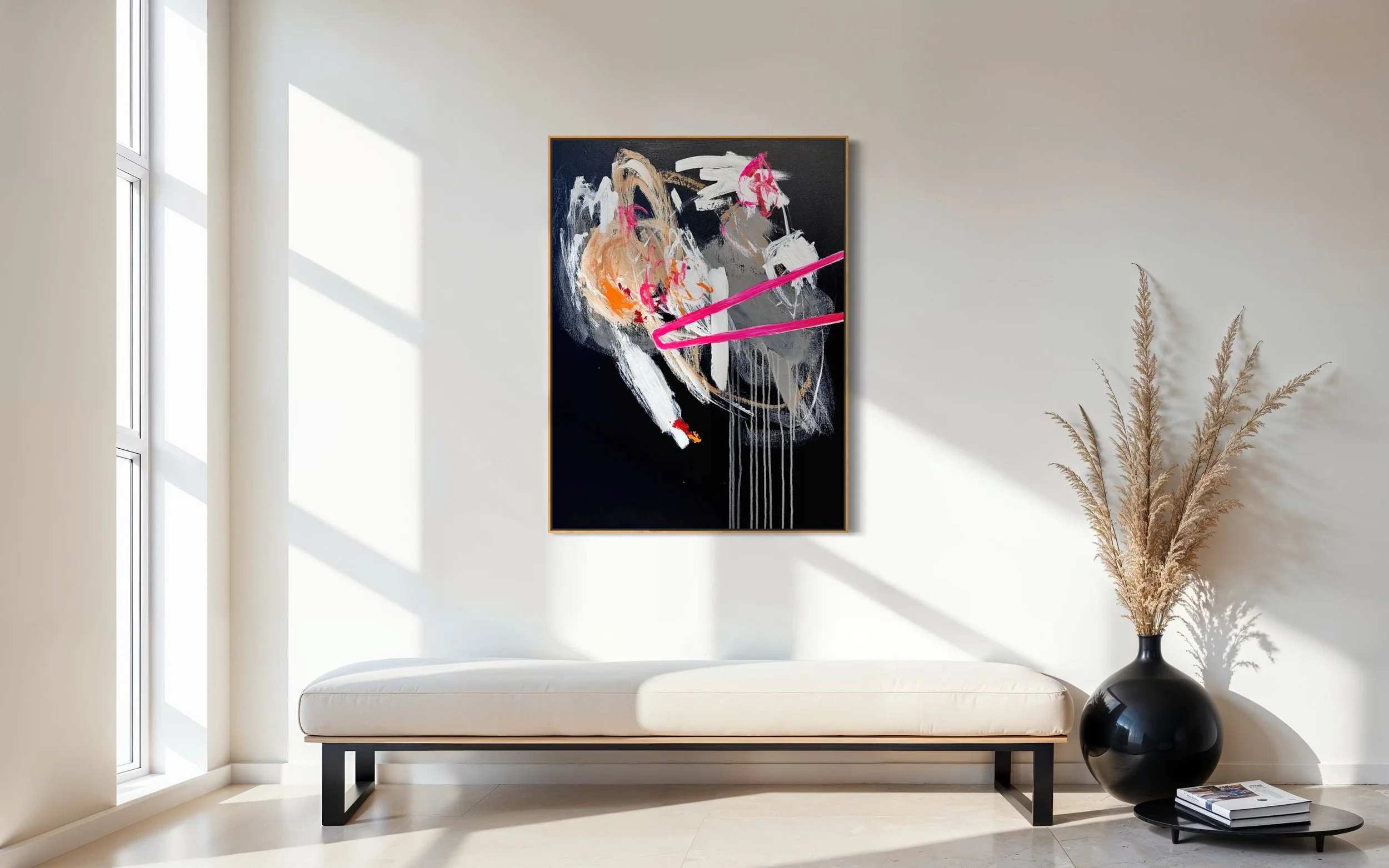 Modern minimalist interior with a white bench, a black vase with dried pampas grass, a stack of books, and a large abstract black, white, orange, pink, and gray painting on the wall by a window