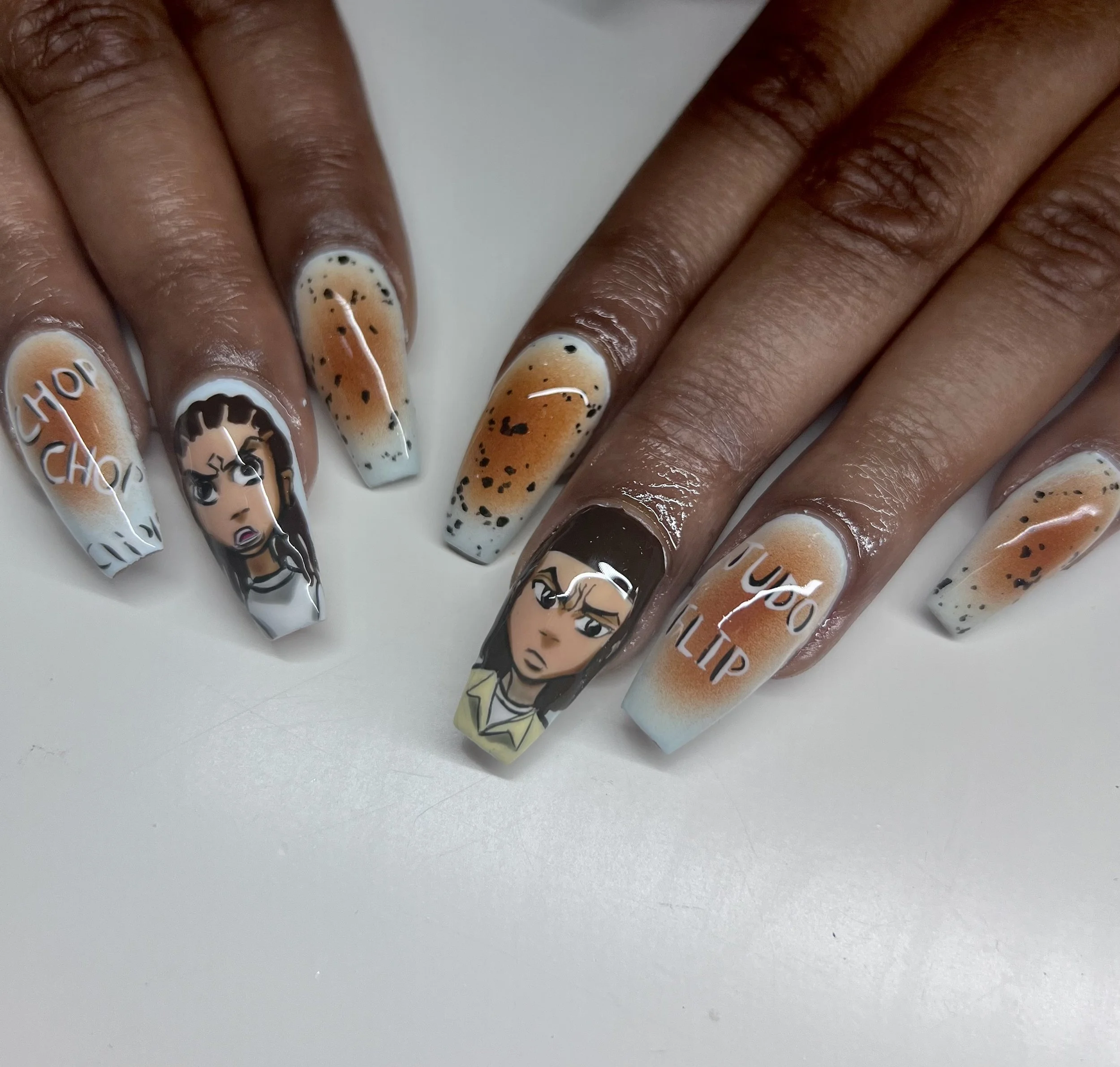 Nail art with cartoon characters from the show "The Boondocks" painted on each nail