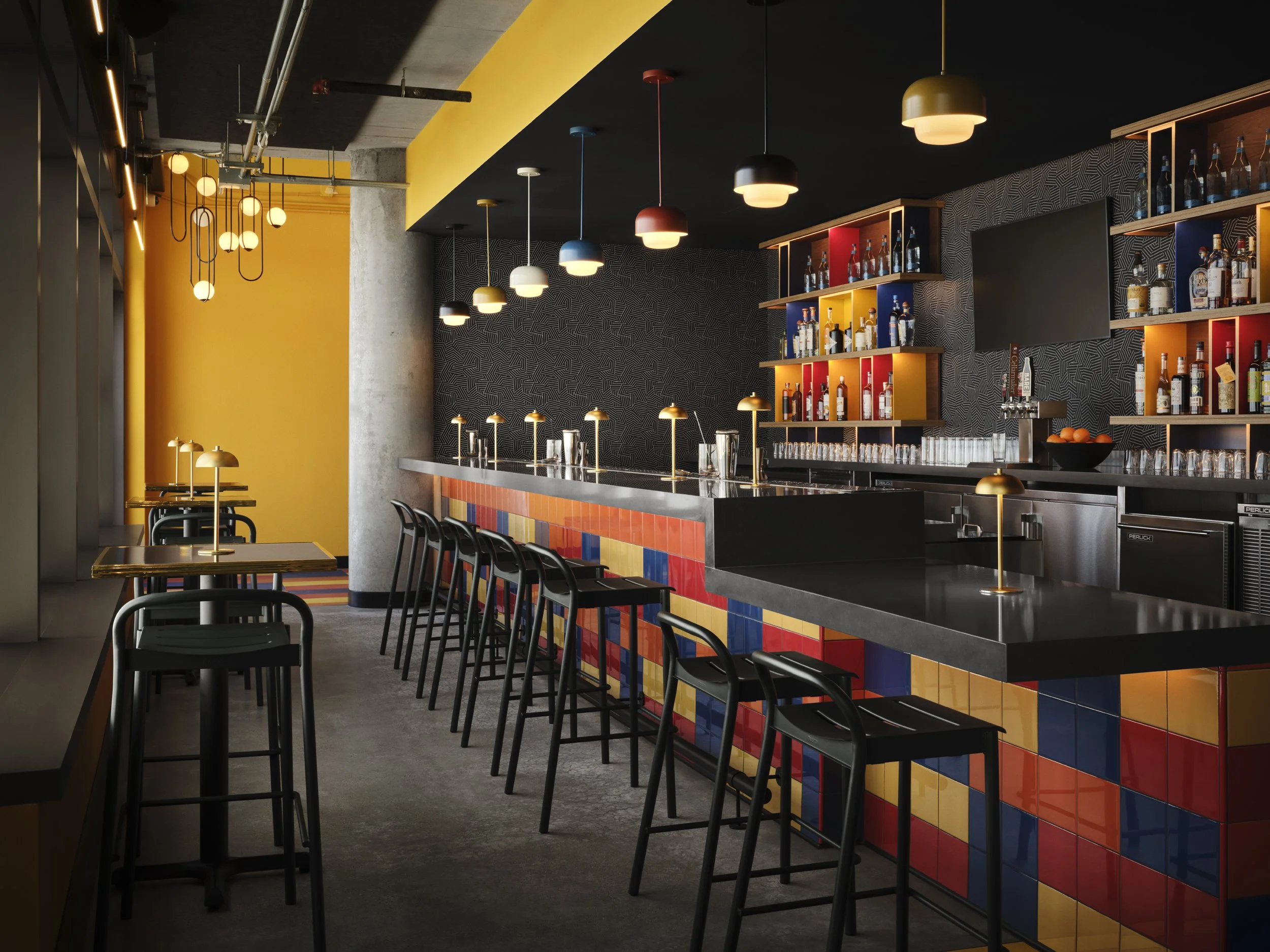 Modern bar interior featuring a colorful tiled bar counter, black chairs, hanging ceiling lights in various colors, and a patterned black and gray wall backdrop with shelves of bottles.