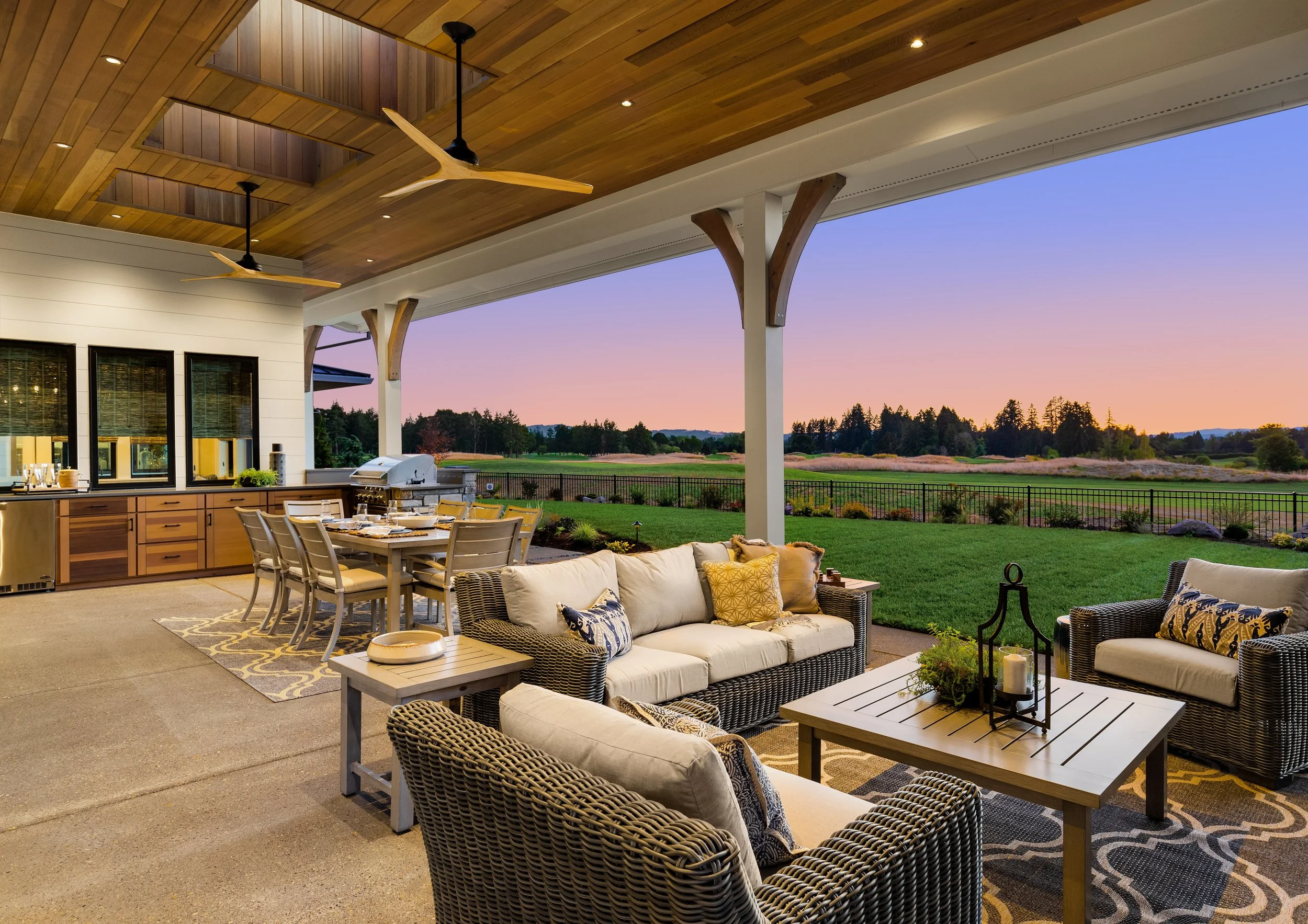 Warm wood paneled, contemporary outdoor living and dining area at dusk