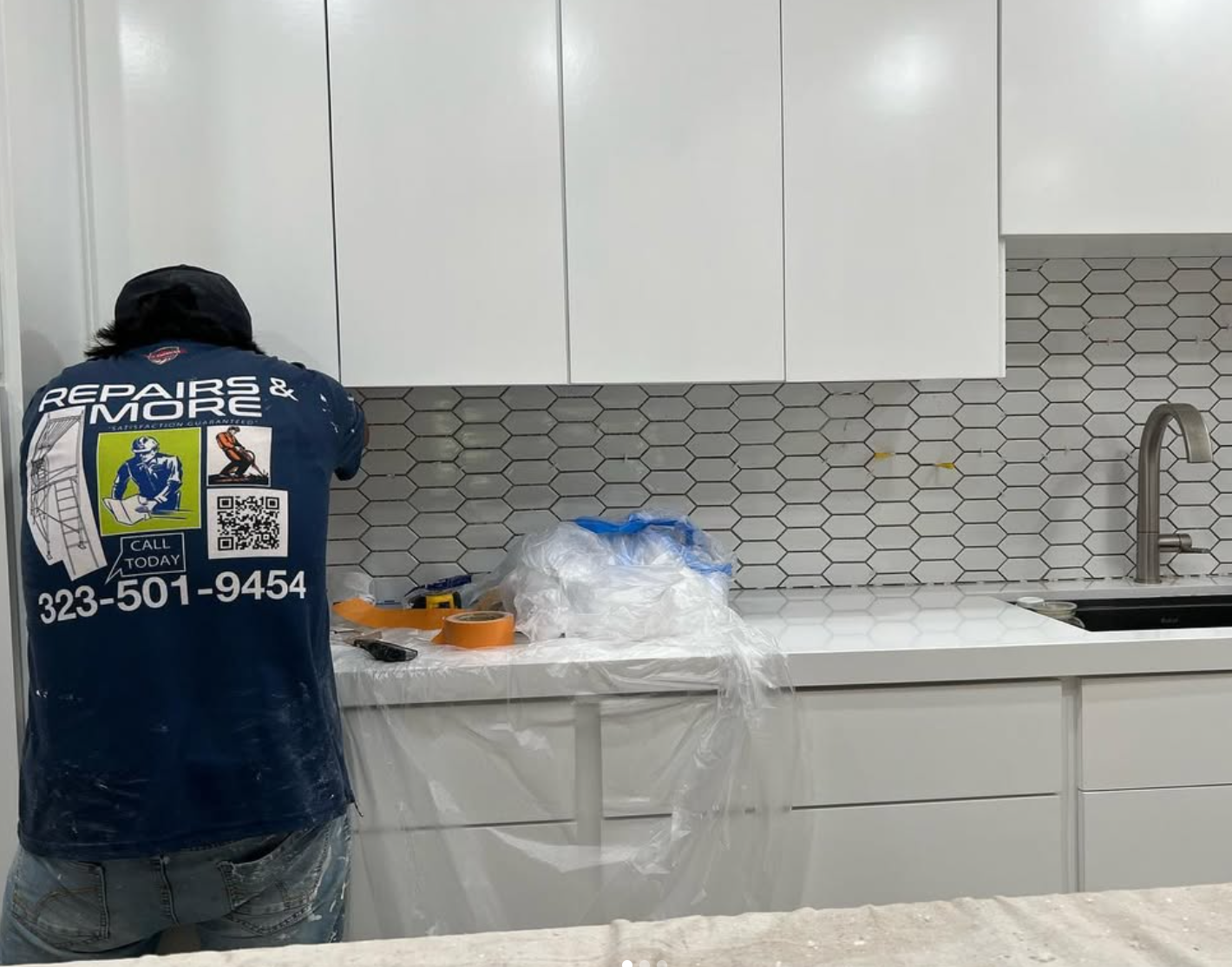 Kitchen renovation by Repairs y More featuring clean white cabinets, modern hexagon tile backsplash, and updated countertops in a Los Angeles area home.