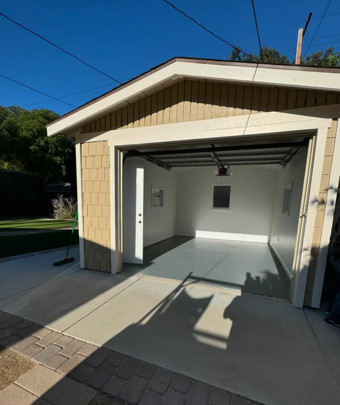 Garage conversion project by Repairs y More showing completed drywall installation, fresh white paint, and smooth grey flooring ready for use as an ADU or living space in Los Angeles County.