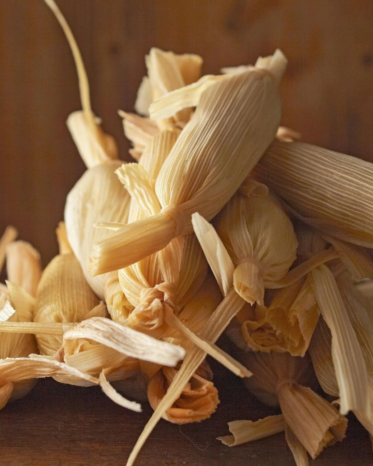 Dried pineapple leaves laid out on a wooden surface