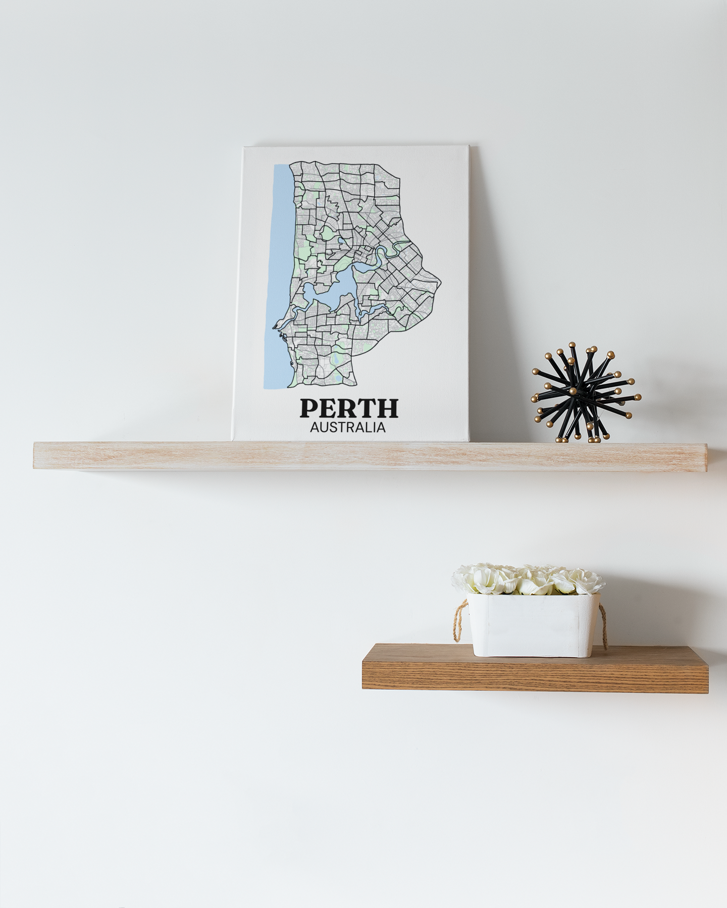 Colour street map canvas print of Perth, Australia displayed on a floating wood shelf beside a spiky black ornament.