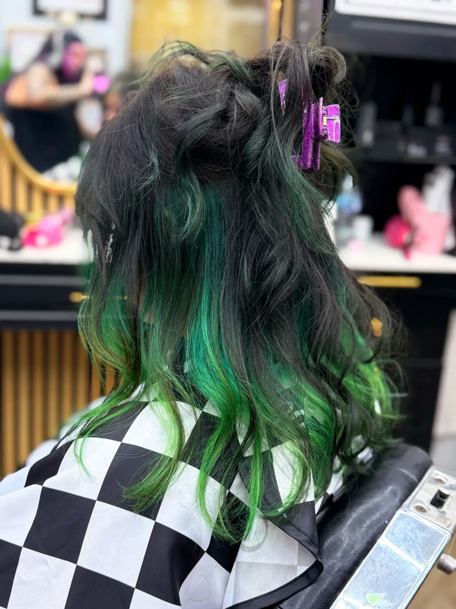 Long dark wavy hair with vivid green peekaboo underlights and balayage placement by Brandi Gross at The Panic Room, an alternative salon in Rapid City SD.