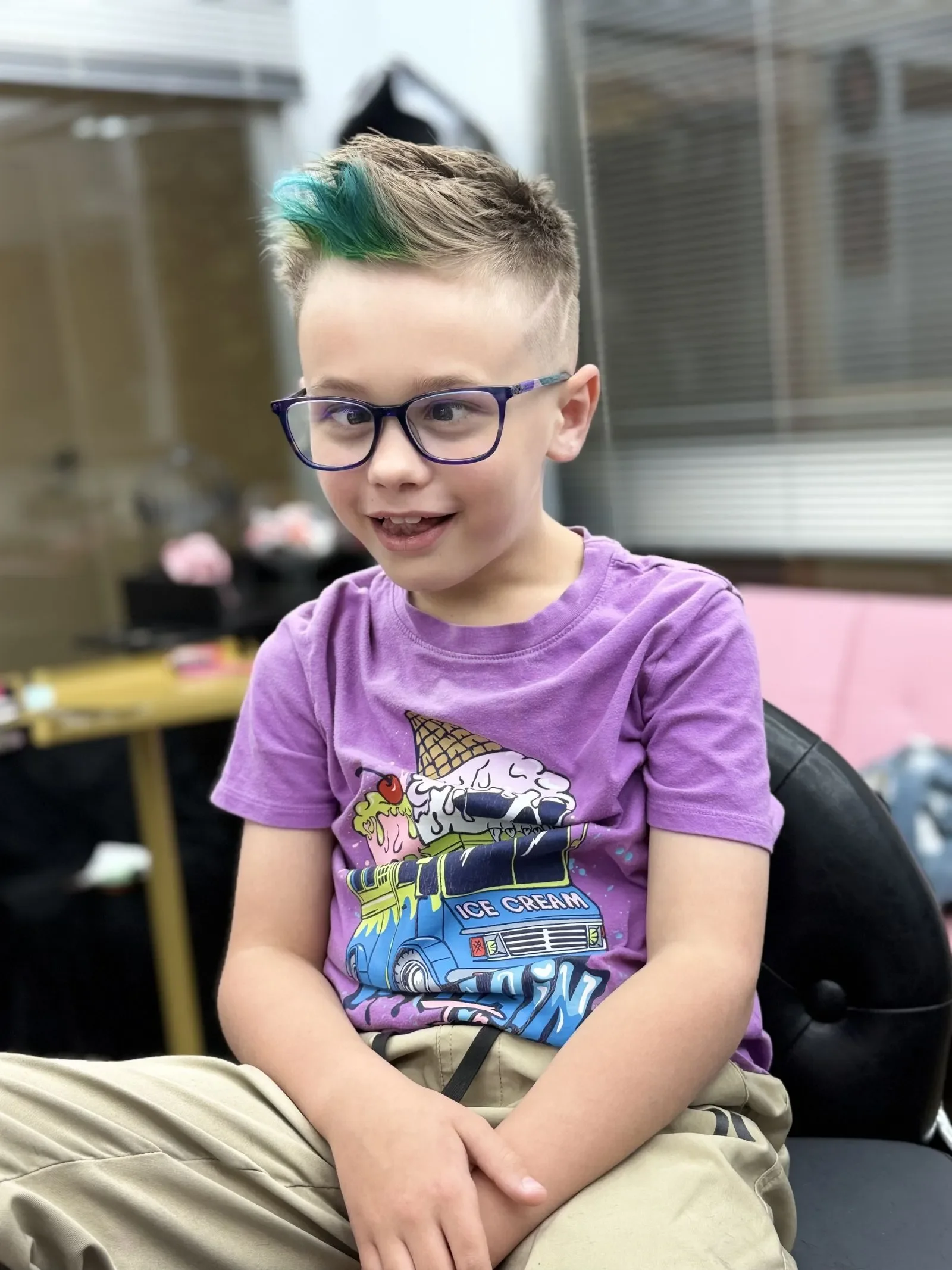 Young boy with a skin fade haircut and teal-green spiked tips at The Panic Room, an alternative barbershop and salon in Rapid City SD.